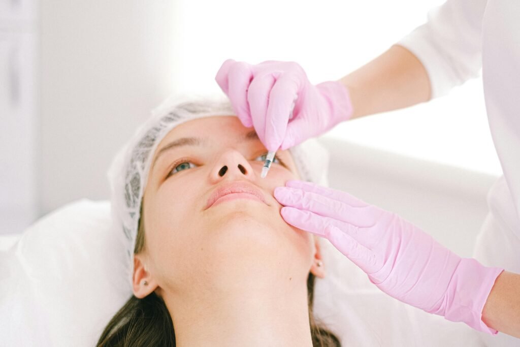 pexels-photo-4586709-4586709 Woman receiving a facial cosmetic injection in a professional clinic setting.