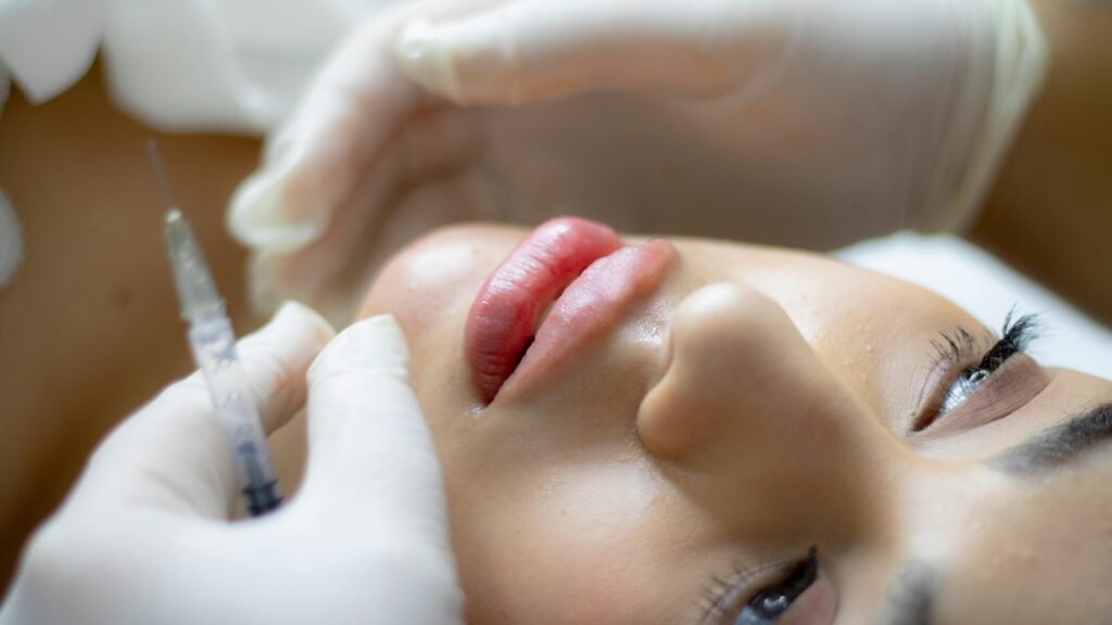 pexels-photo-9157201-9157201 Close-up of a woman receiving a lip augmentation with a syringe by a professional.